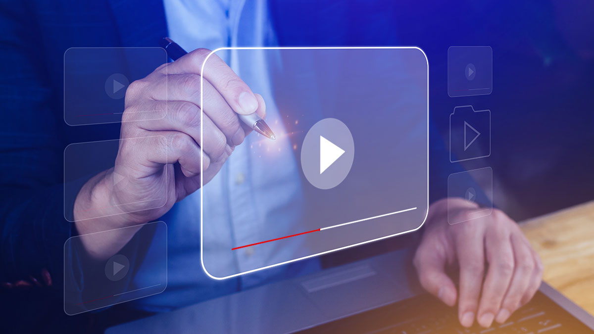 A man clicking on a play button with a pen