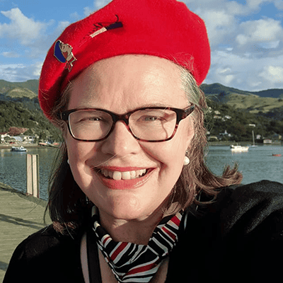 Picture of woman wearing a red beret and a red, white and black scarf.